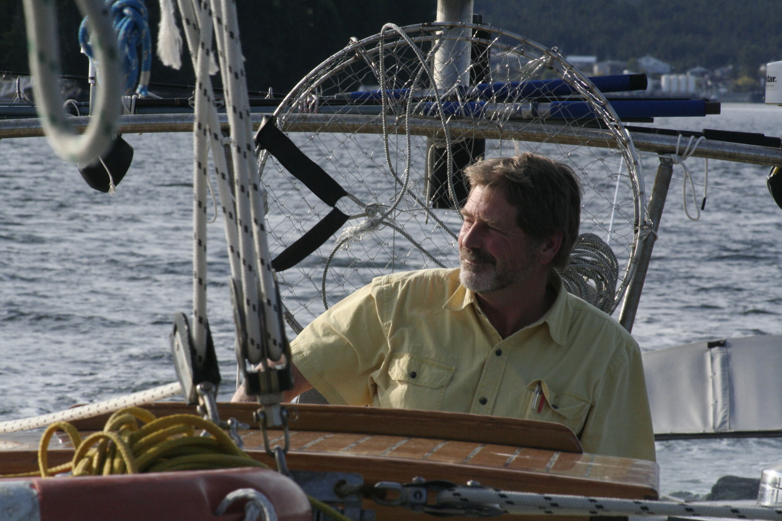 Brian Falconer at the helm of a boat.