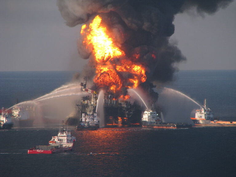 An oil rig is on fire in the ocean.