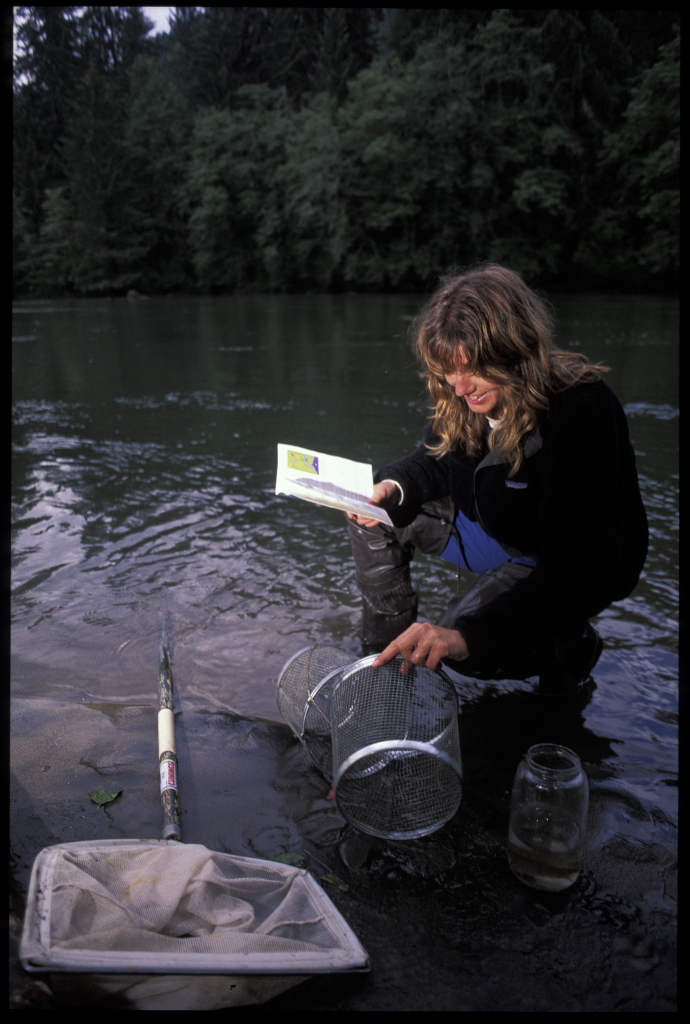 Raincoast researcher studies a salmon bearing stream
