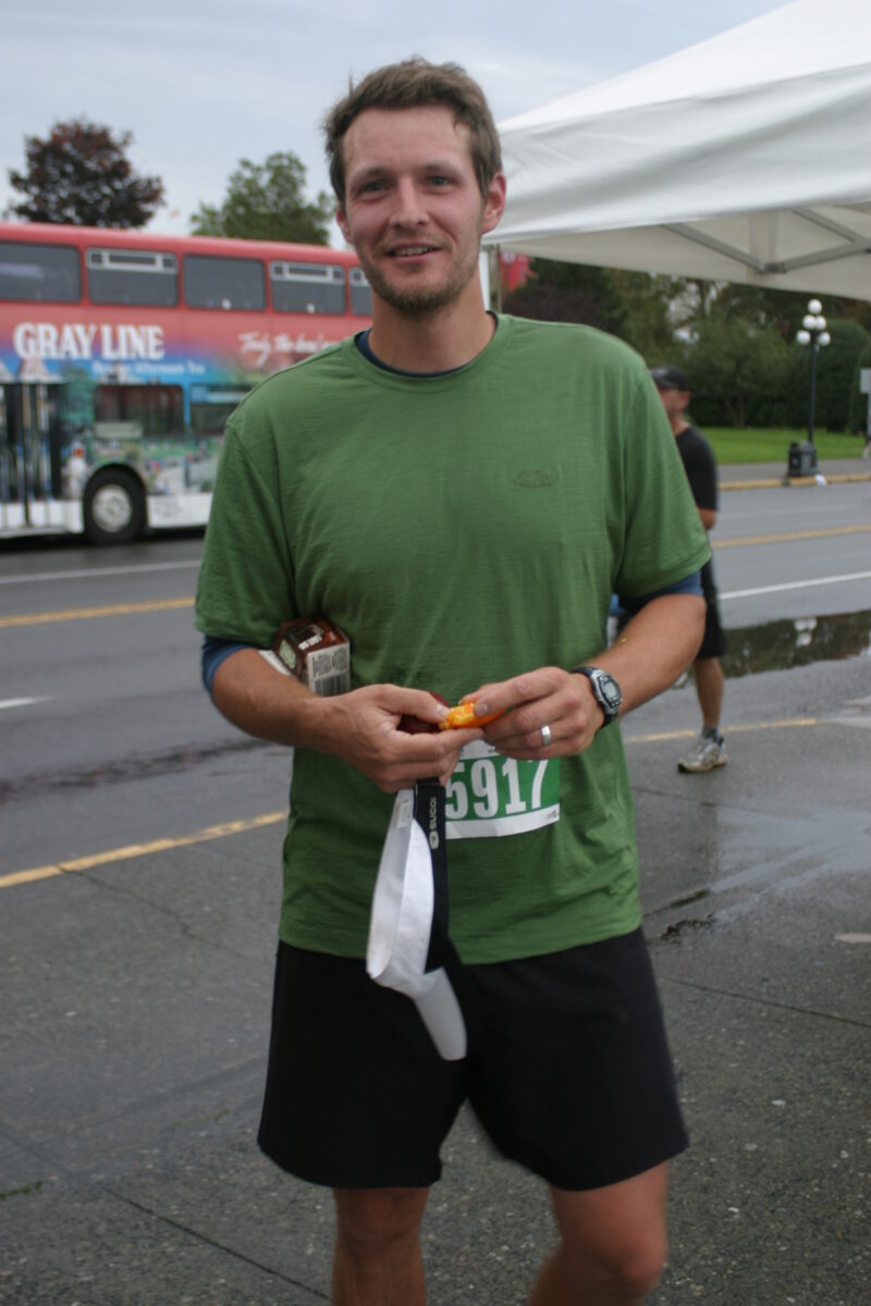 A man wearing a green t-shirt. Race for Raincoast.