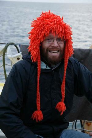 A man wearing an orange hat on a boat.