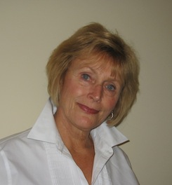 A woman in a white shirt posing for a photo.