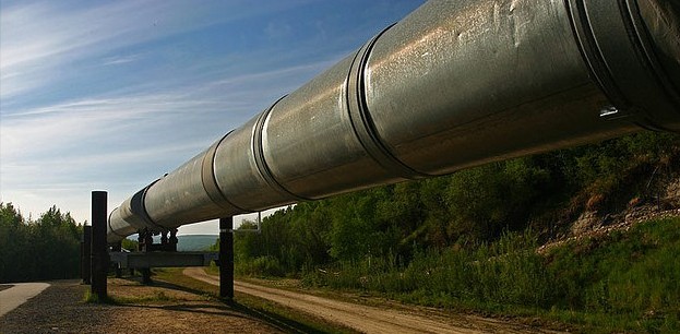 Pipeline, above ground, spanning from close-up to the horizon.