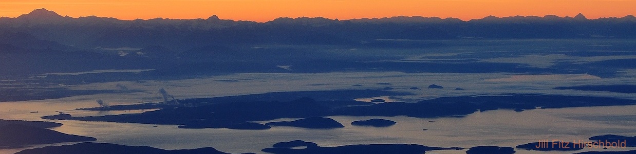 An aerial view of a mountain range at sunset.