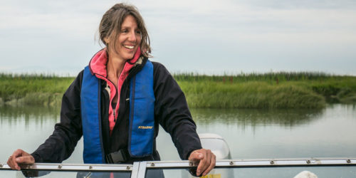 Misty MacDuffee looks over the front of a boat on the Lower Fraser River.