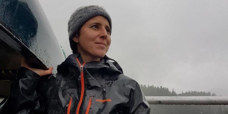 Marlie Van Roy lifts a canoe in preparation for departure.