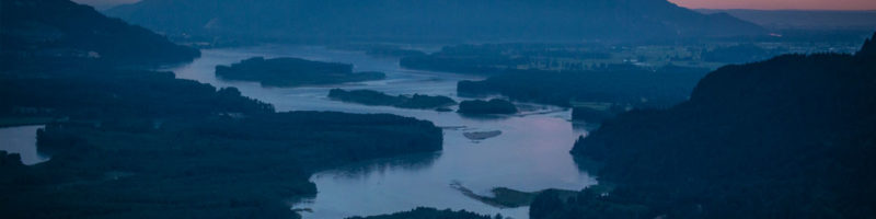 Dusk settles over the mountains and waters of the Fraser River watershed (aerial view).