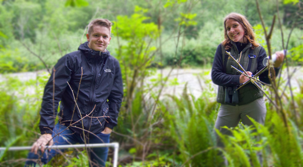 Vancouver Island University students Jack and Sam assist in conducting vegetation surveys along the river bank.