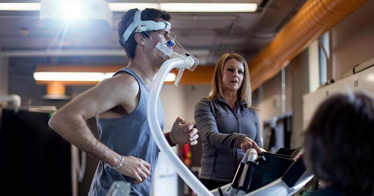 Gio runs on the treadmill with a CO2 mask testing his oxygen uptake.