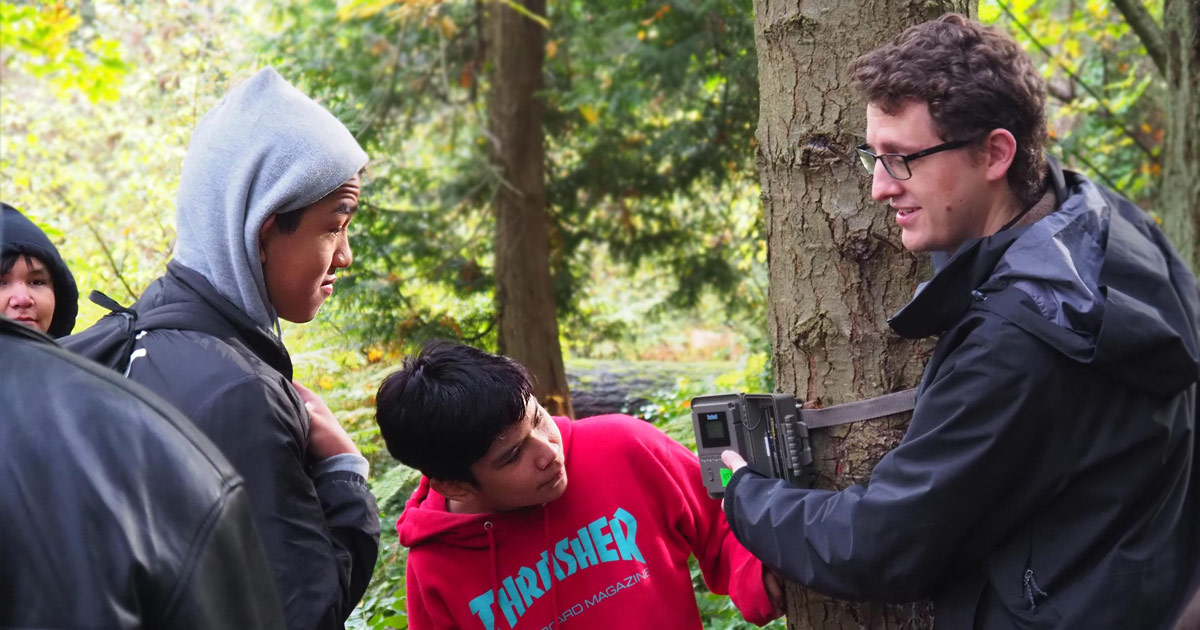Tyler Jessen helps some young Salish Sea Emerging Stewards on campus to examine a remote sensing device.