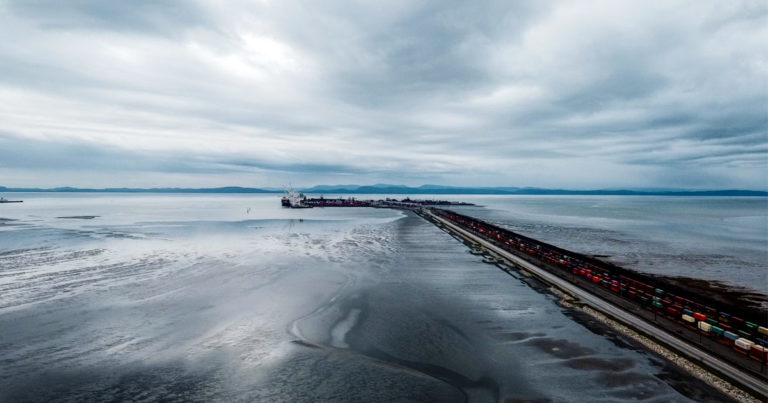 Terminal 2 at the end of a long causeway, with Vancouver Island in the distance.