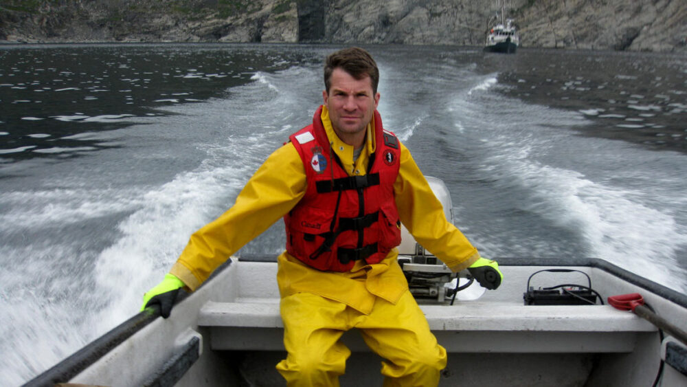 Peter Ross drives a boat in the waters of Labrador.