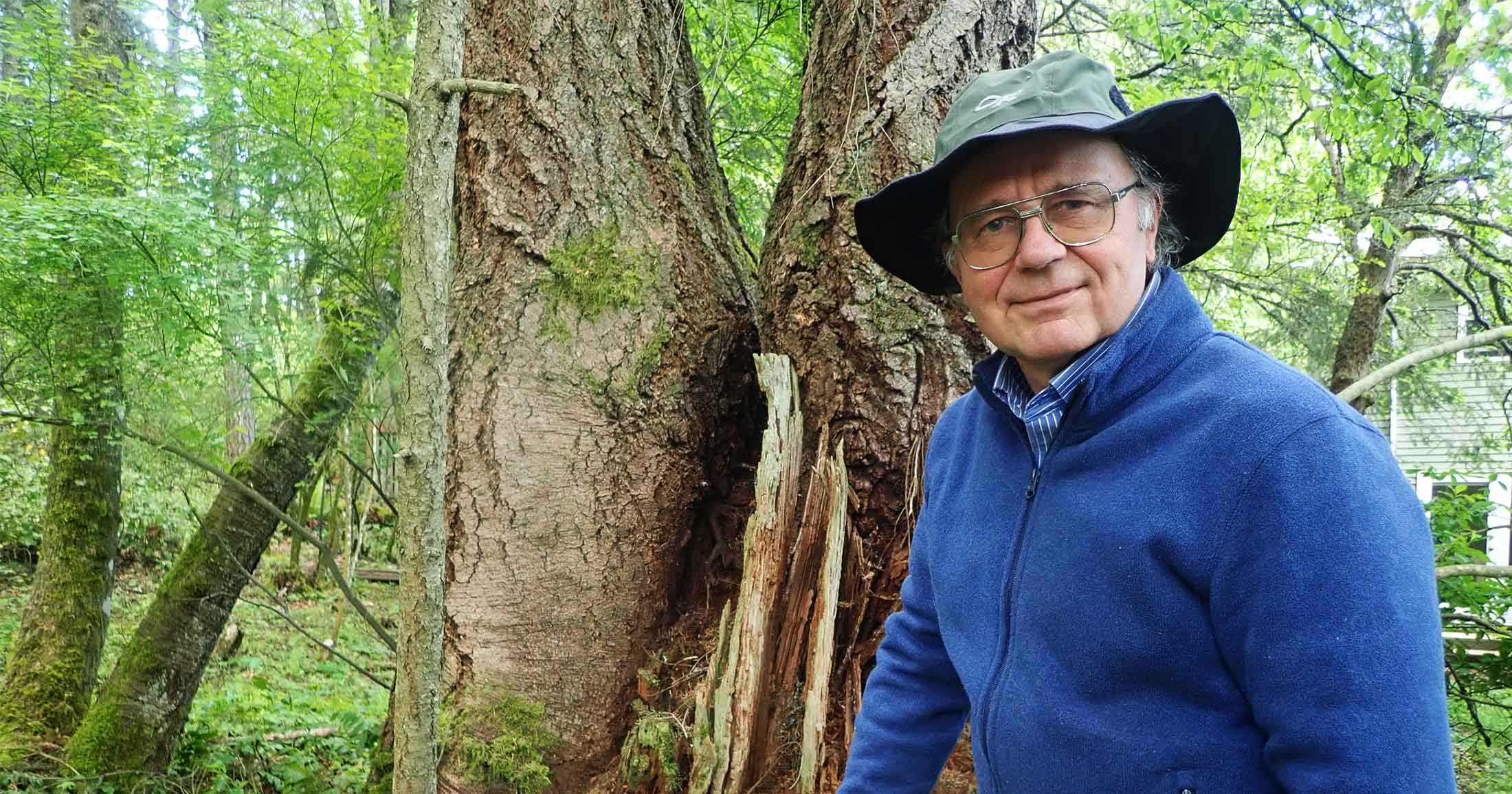 Richard Hebda standing in front of a stump.