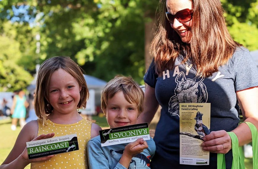 Mother and two children in the sun holding Raincoast printed materials.