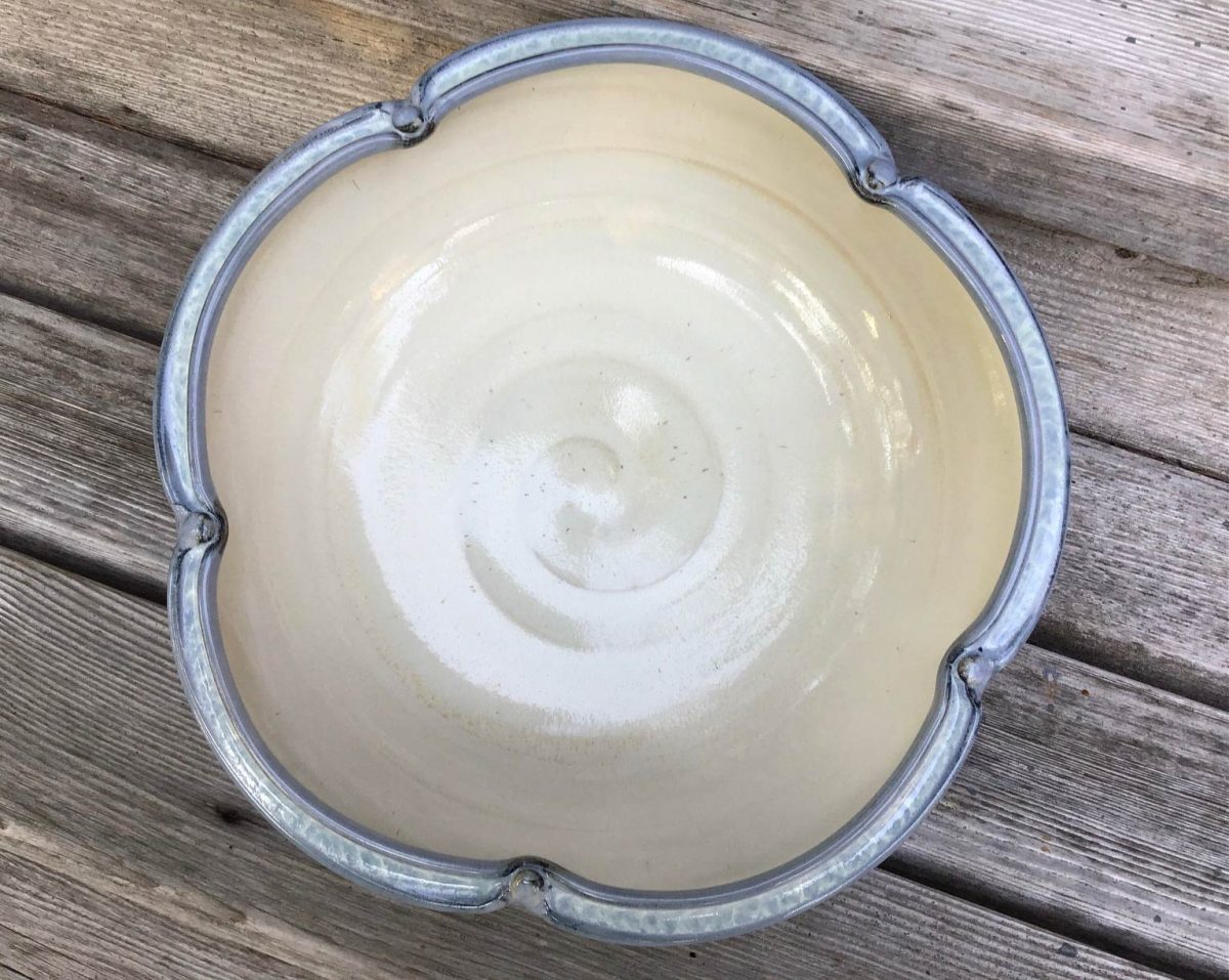 A white pottery bowl with blue outside.