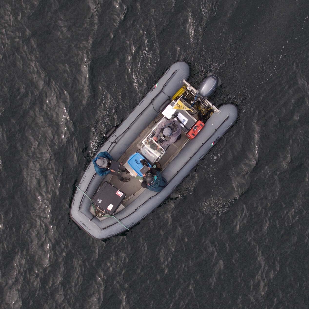 Overhead photo of a zodiac filled with scientists and equipment.