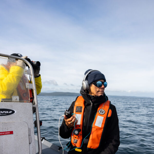 Scientists on a boat doing photogammetry on the coast of BC.