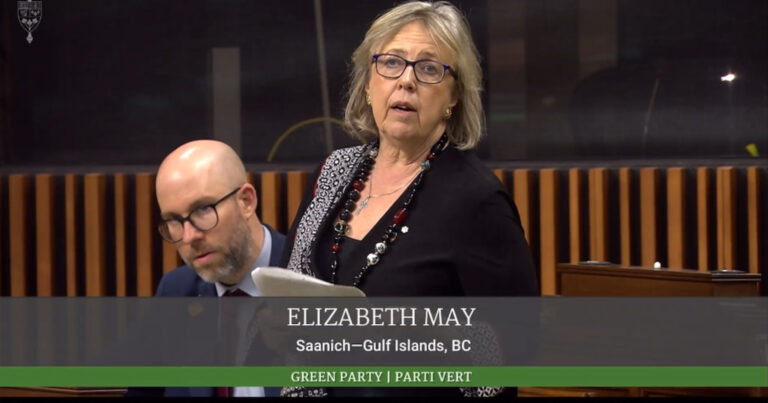 Elizabeth May reading from a paper in the House of Commons.