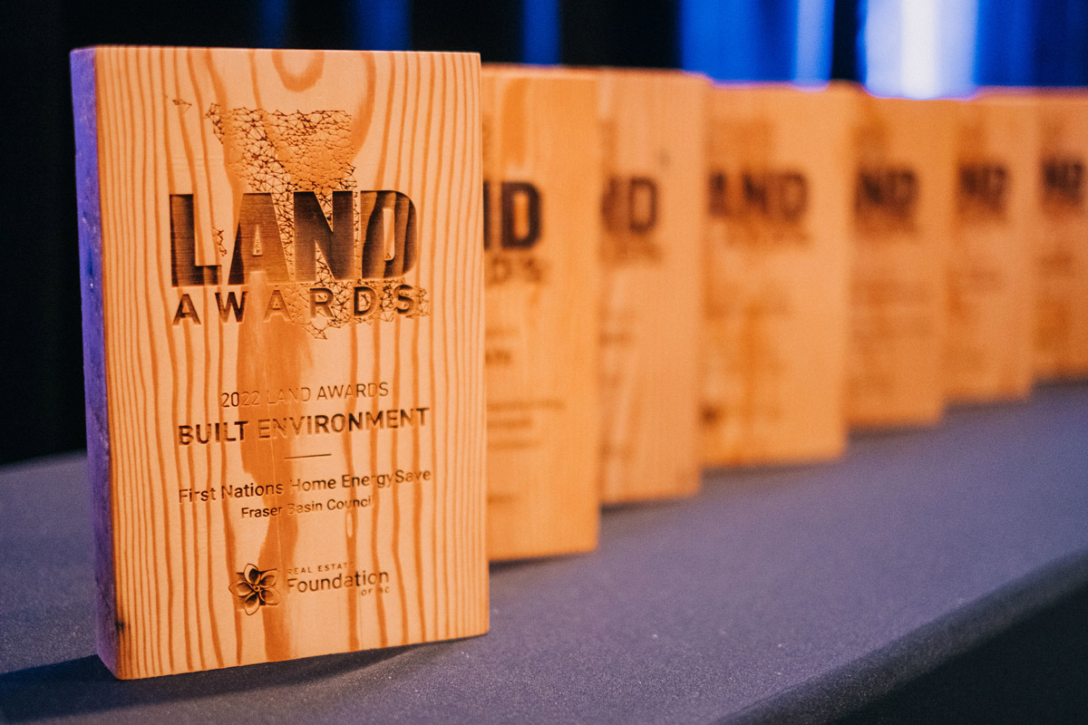 Land Awards from 2022 sit in a row on a table, displaying their beautiful etched and burned designs.
