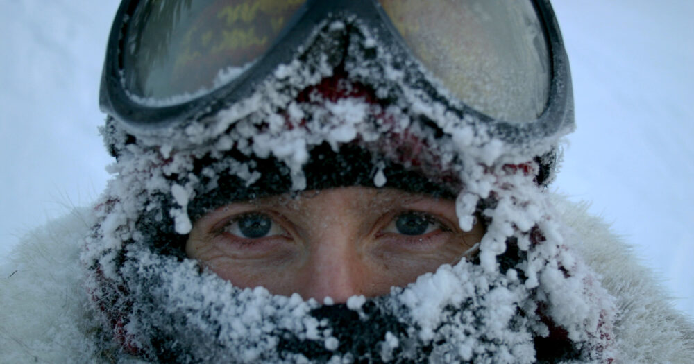 Astrid Vik Stronen in the snow and ice on Moon Lake in January, with ski goggles and icicles dangling from her toque and scarf.