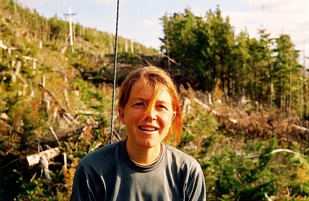 Gudrun Gudy Pflüger stands in a cutblock.