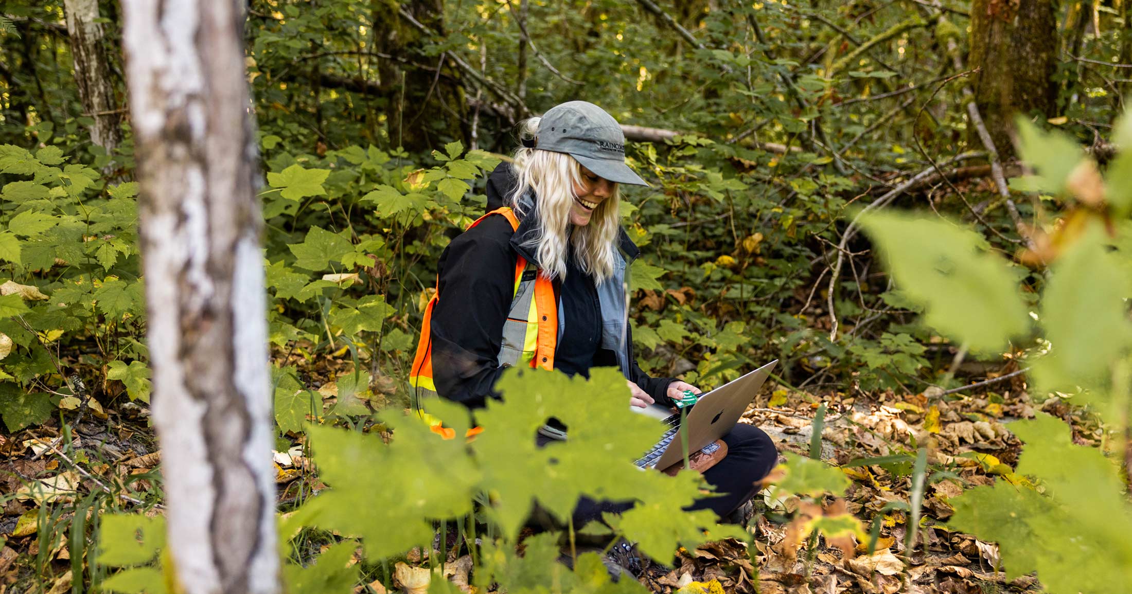Chelsea Greer sits down in a small clearing while working in the field.