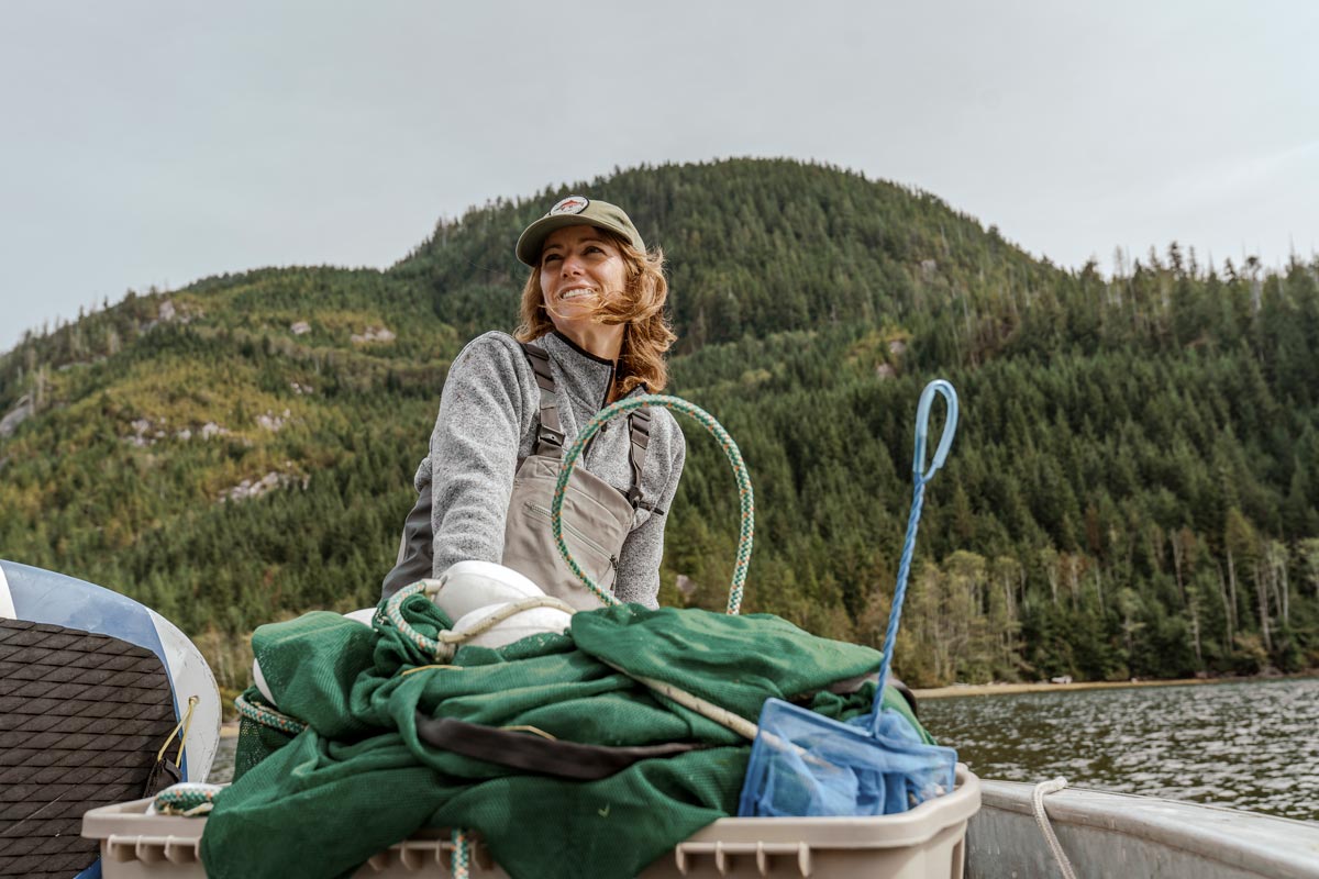Jessica Hutchinson, executive director of Redd Fish Restoration, working outdoors, on the water, always smiling.