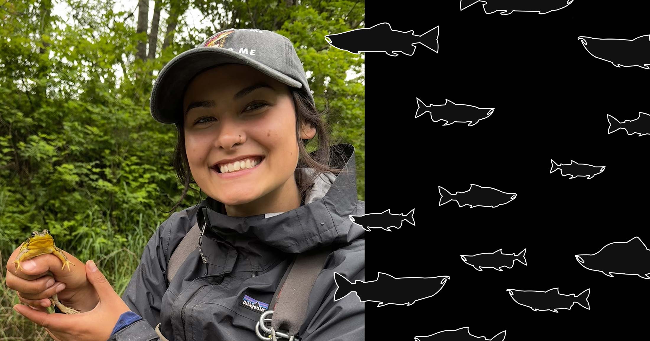 Arielle Koenig stands by a stream holding a frog and smiling boradly in her overalls and rainjacket - episode 14 of "More Than a Fish."