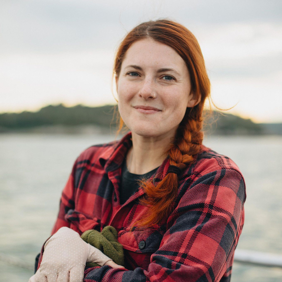 Jaclyn Aubin wears red and black plaid while working on the water.