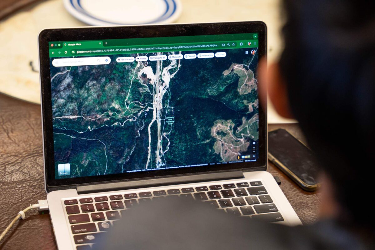 A laptop with a satellite map of Coldwater Creek Provincial Park on the screen. 