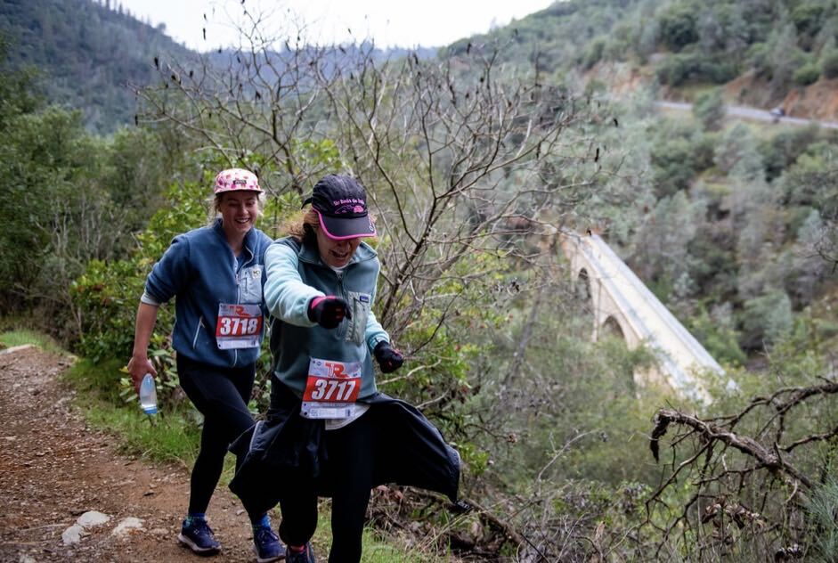 Paige and her mother, Erica, smile while racing through a dusty valley.